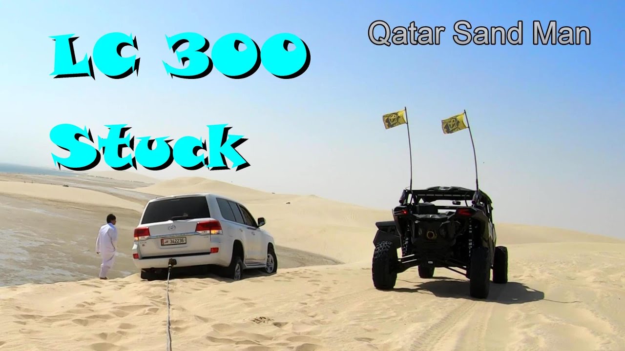 Toyota land cruiser LC300 stuck at the top of a sand dune at Sealine Beach Qatar