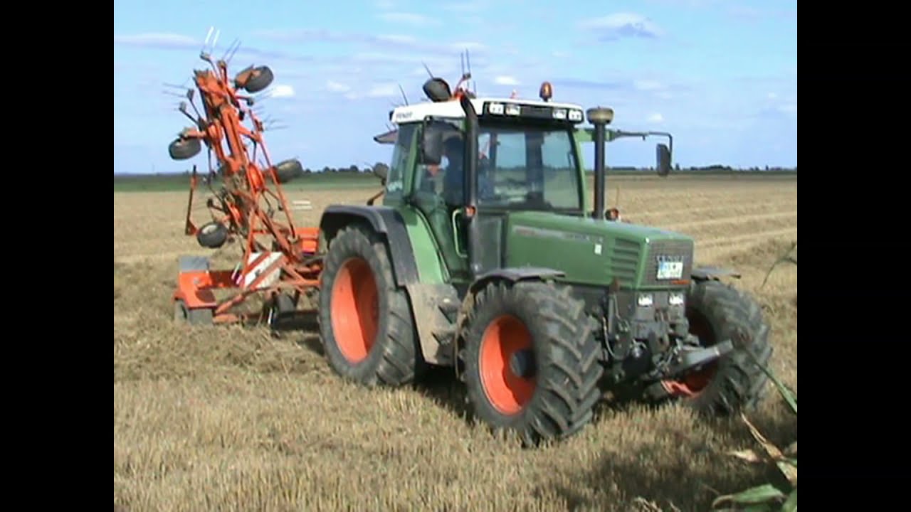 FENDT FARMER 312 AND KUHN TEDDER WORKING IN STRAW AND GRASS