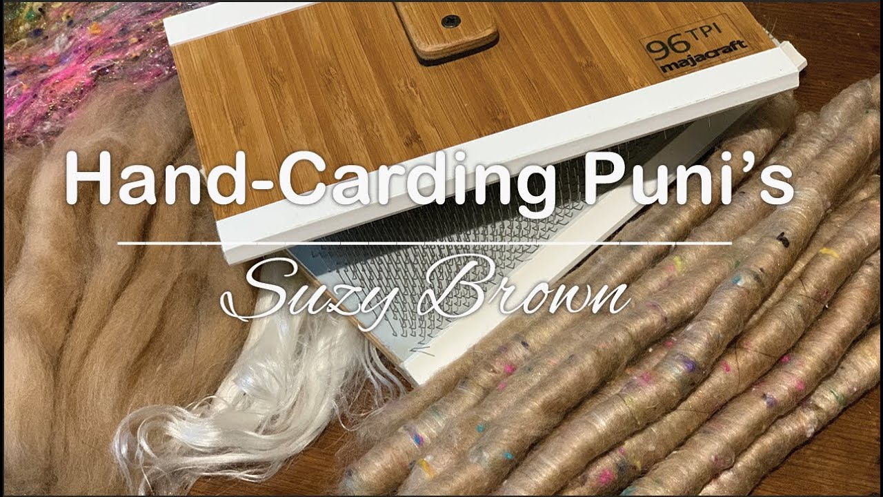 Hand-carding a puni for spinning