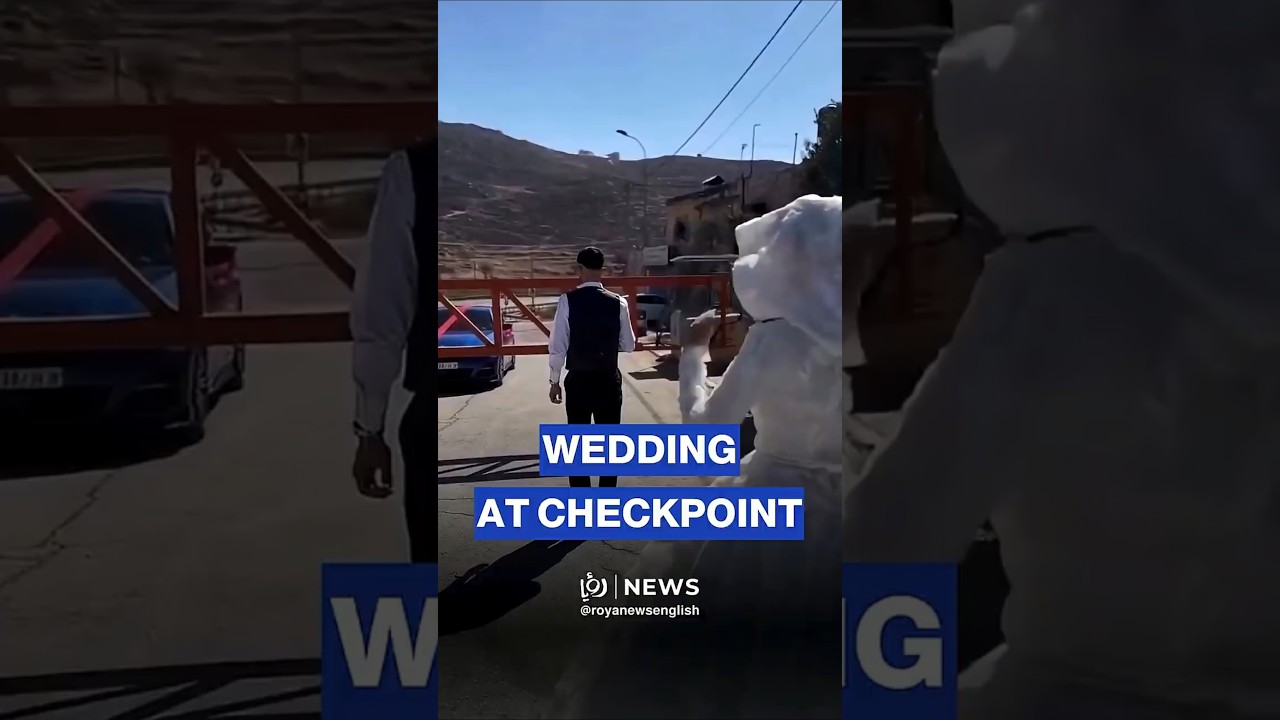 Palestinian groom meets his bride at an &lsquo;Israeli&rsquo; checkpoint in the West Bank
