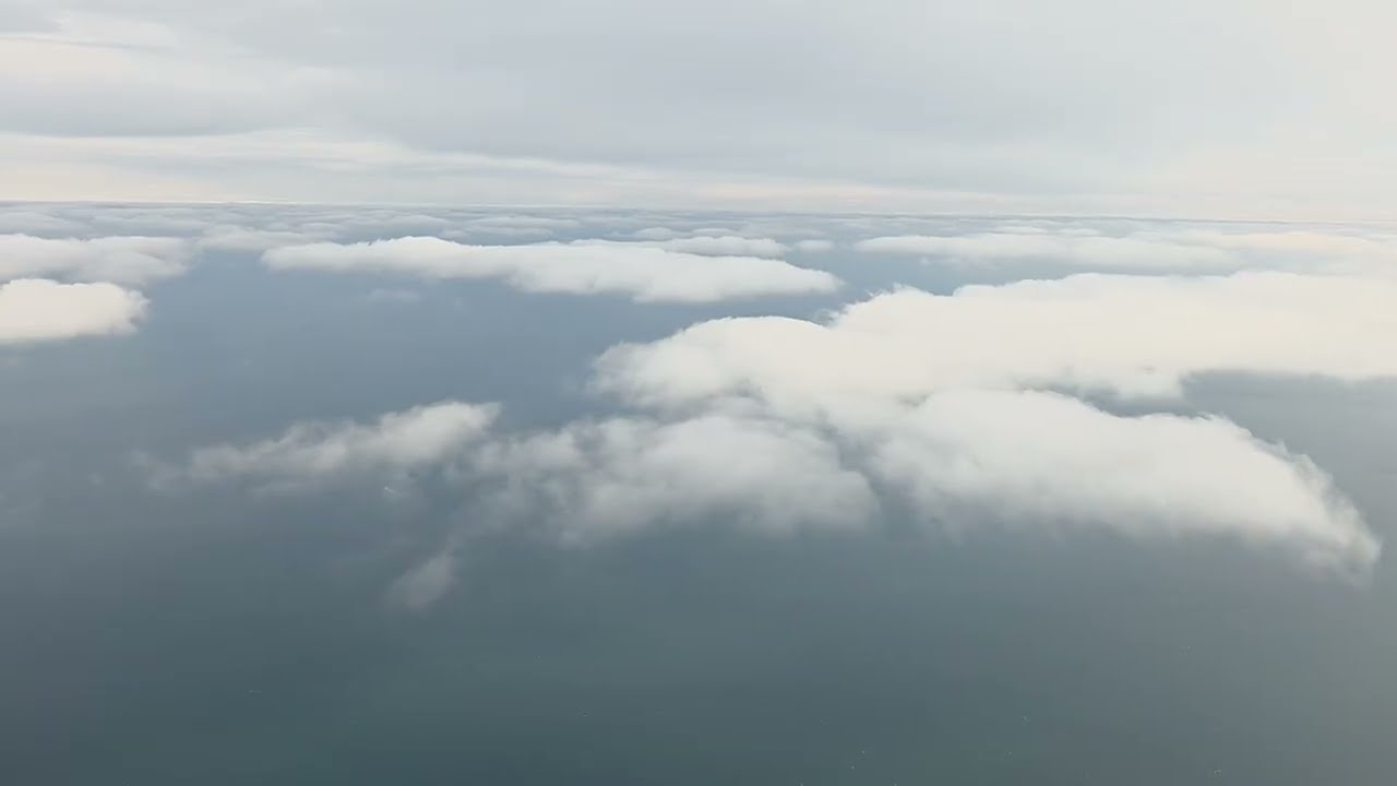Relaxing view from the plane. Clouds and airplane landing.