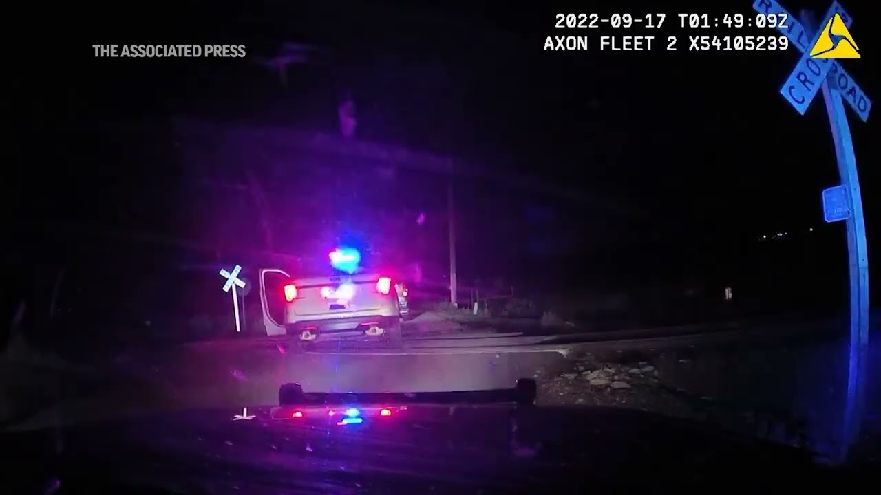 Officer who put woman in a police car hit by a train didn't know it was on the tracks, defense says