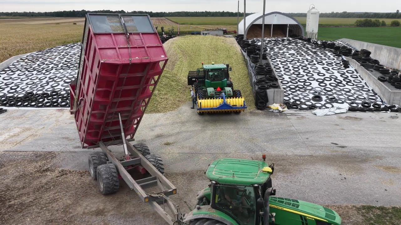 CANADIAN FARMER - STOCKPILING WINTER FEED. Adding more corn silage to the silo bunker to meet demand