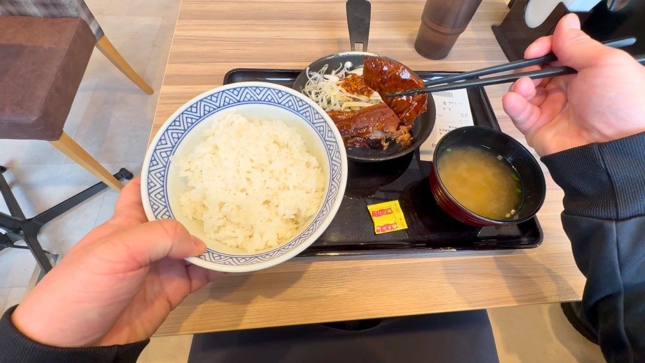 A Japanese Nurse Eating Thick-Cut Braised Pork Set Meal at Yoshinoya