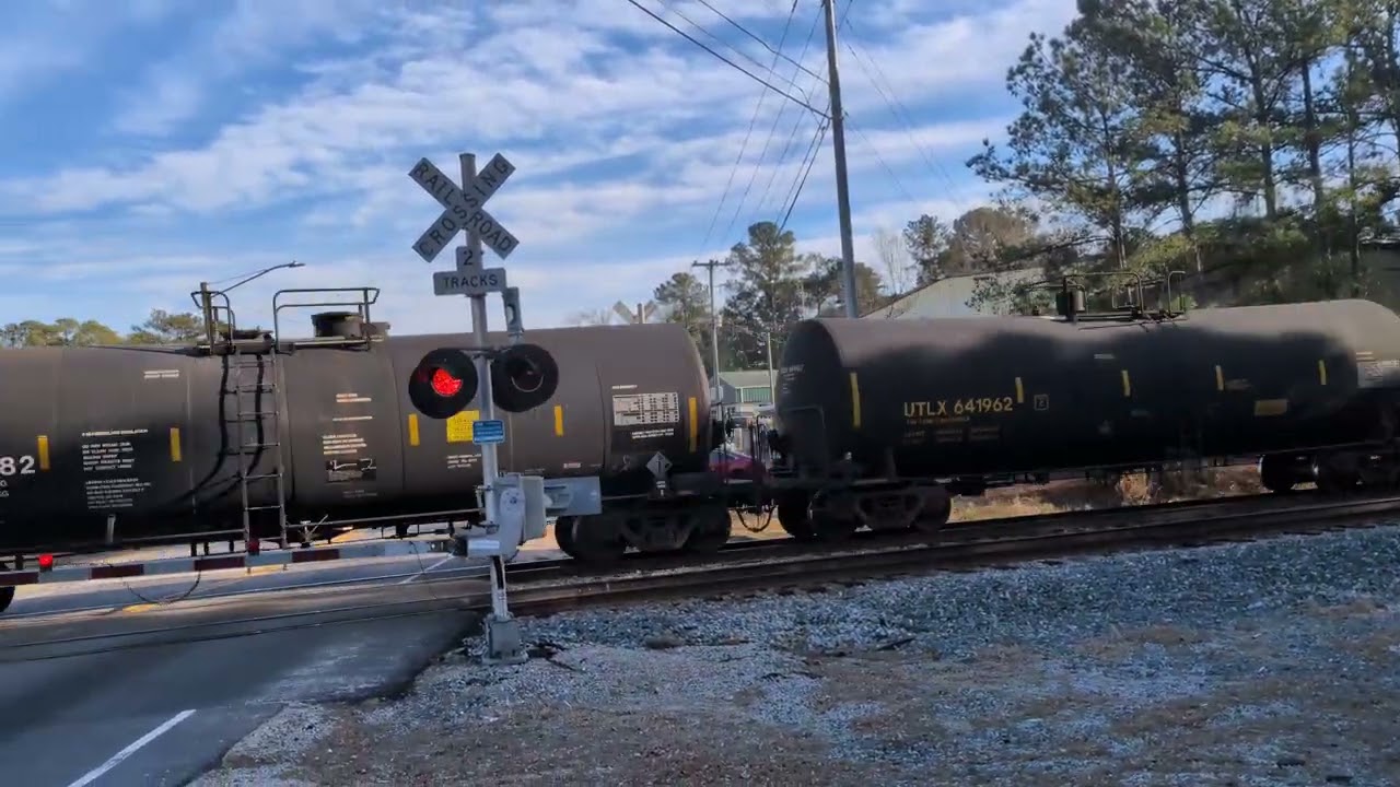 A Pearce's Mill fire department truck makes a stop for CSX 3349 and CSX 4558 at Whitfield Street 