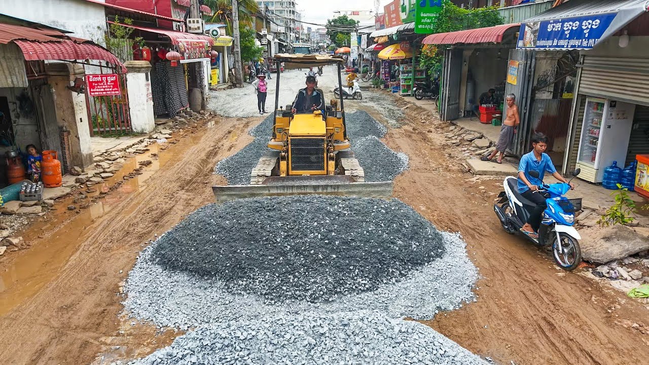 Good Skilled bulldozer pushing Gravel To build foundation road with dump truck Transport Gravel