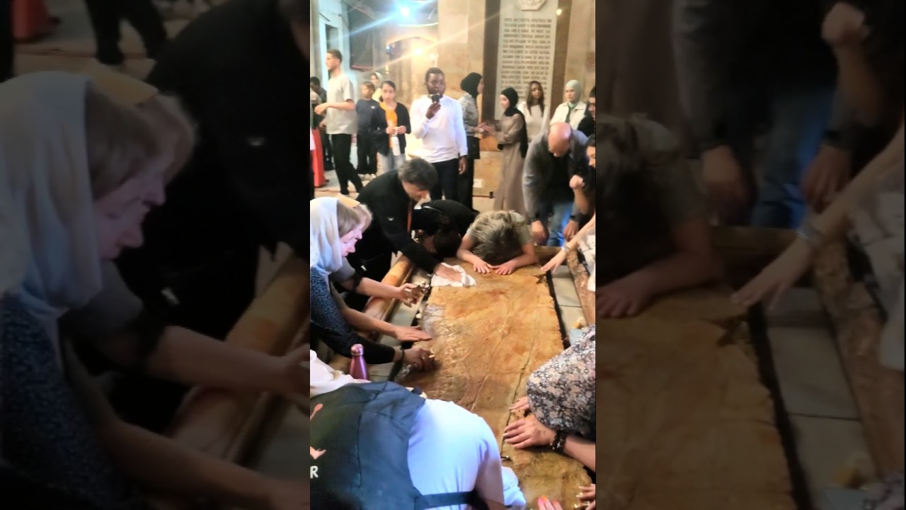 Pilgrims Cover the Anointing Stone with Prayer - Holy Sepulchre Jerusalem