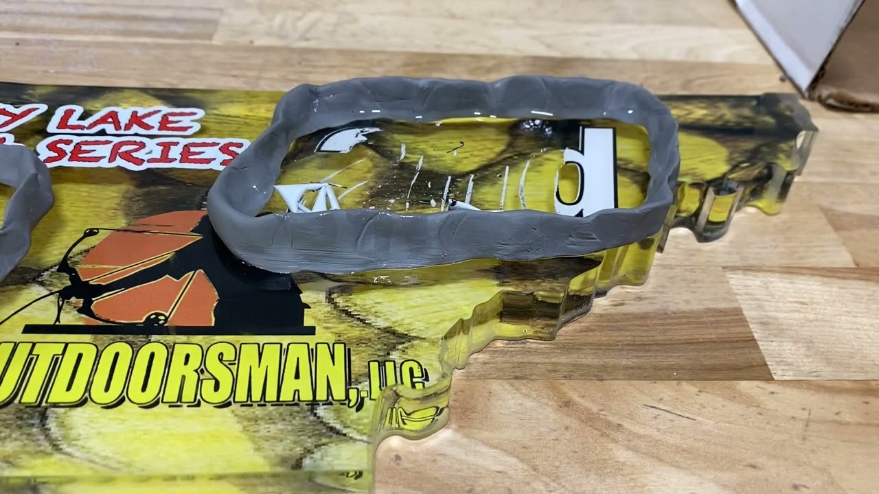 Removing only certain UV misprinted areas from an acrylic award.