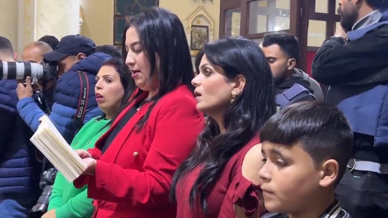 Palestinian Christians pray inside the Church of the Holy Family in Gaza City on Christmas Eve