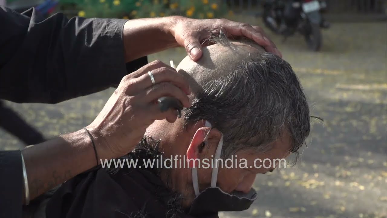Full tonsure: Man gets head shaved at road side saloon: Life lived on streets of India's cities