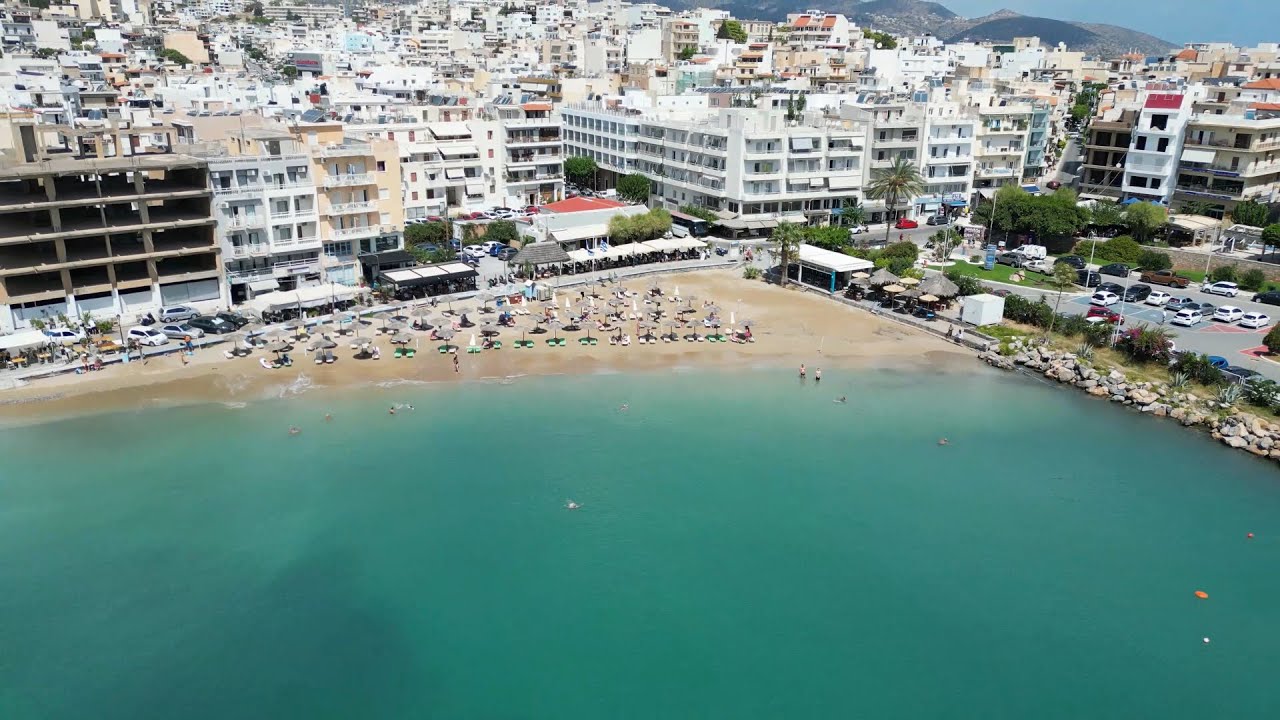 Ammos Beach, the best sandy town beach in Agios Nikolaos, Crete; 4K DJI Drone, Greece