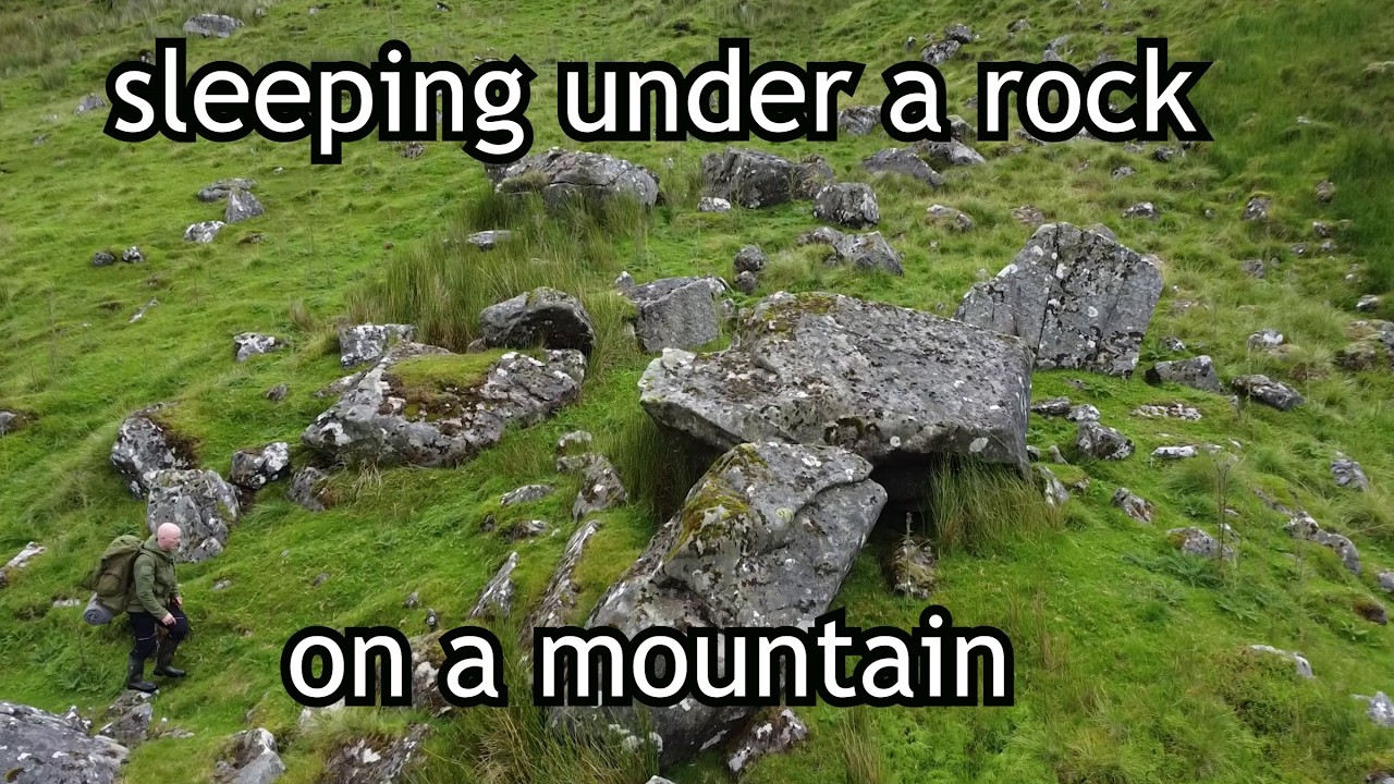 Rainy night camping under a rock in Ireland