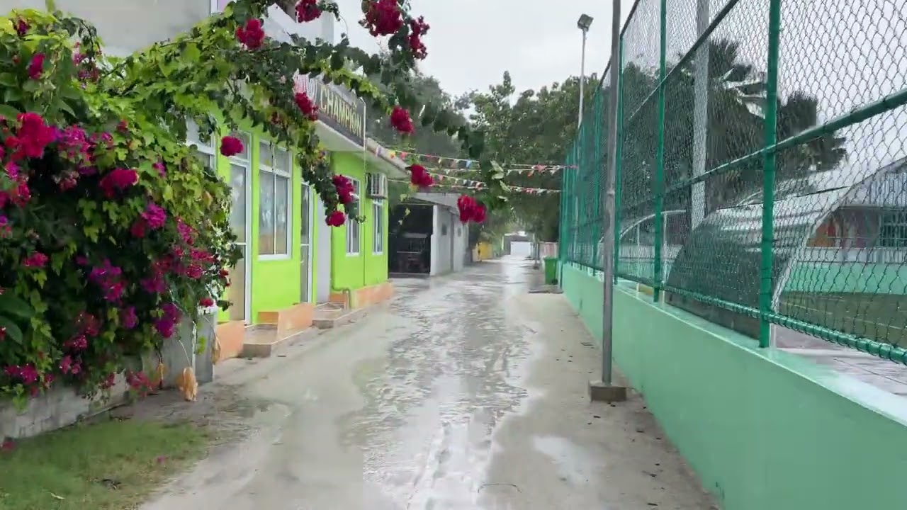 walk in heavy rain, Maldives Dharavandhoo island town