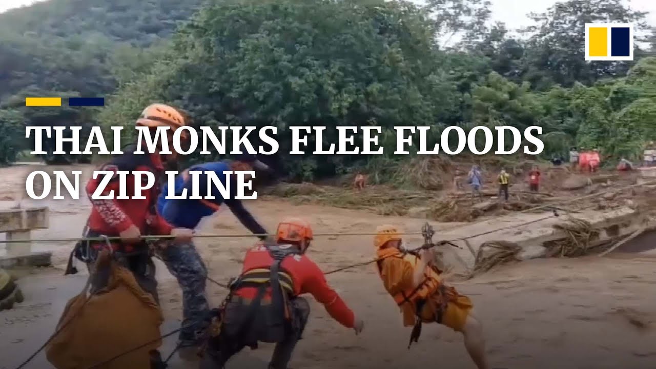 Buddhist monks use zip line to cross flood-swollen river in Thailand after bridge collapse