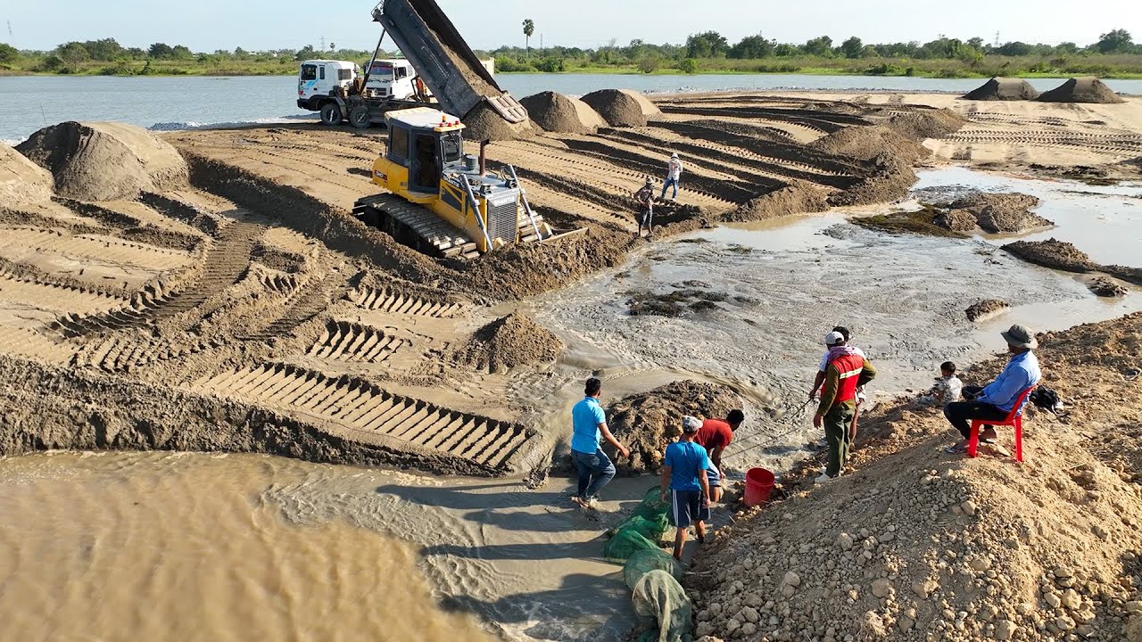 Good job!! The sand truck and bulldozer are expertly pushing the lake.