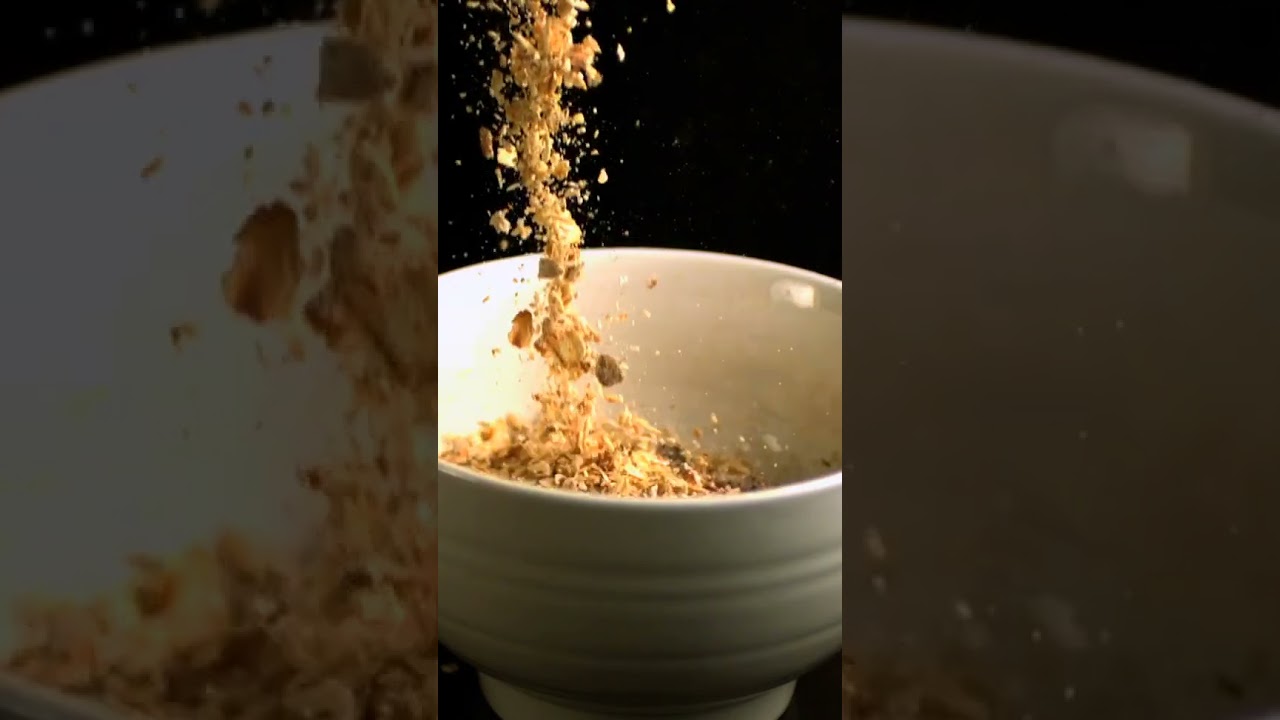 Muesli Pouring into White Bowl in Slow Motion Video | WaveBreak Media #shorts