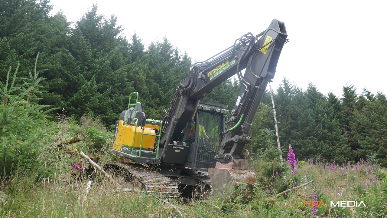 Volvo EC140E mounding on a steep slope in Scotland