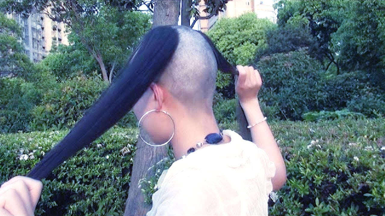 Long hair girl shaved her head in the park