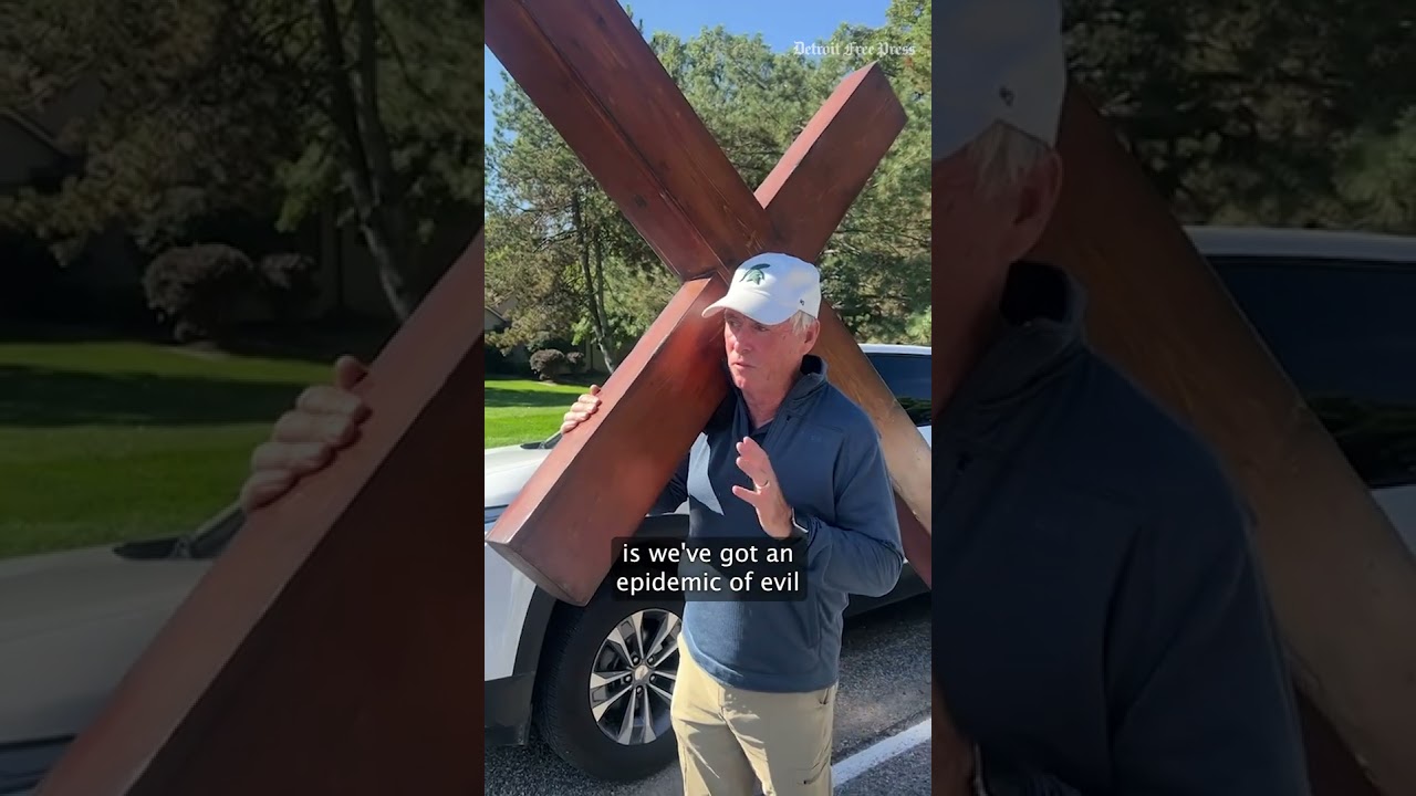 Michigan man carries wooden cross to site of deadly LDS church shooting in Grand Blanc