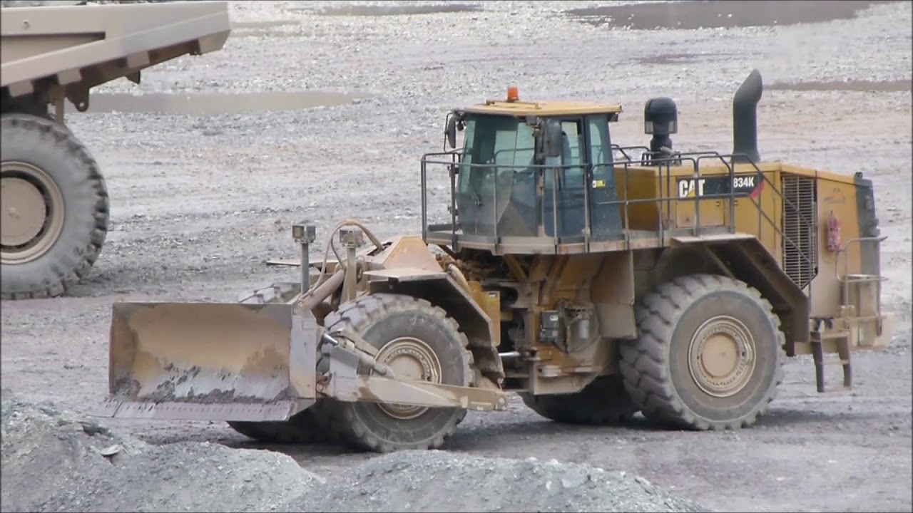 Big CAT Caterpillar 834K wheel dozer cleans up dump site at Mount Iron / Erzberg