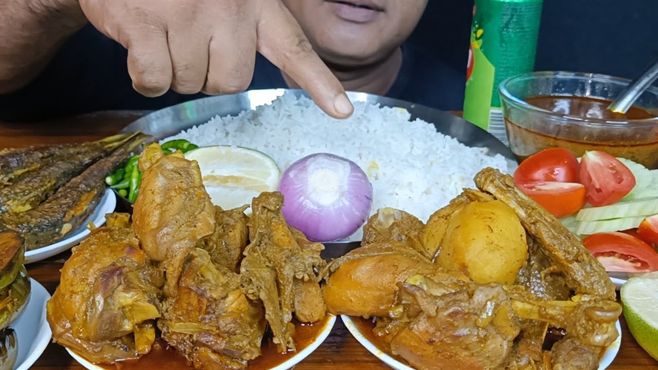 Eating Spicy Desi Chicken Curry With White Rice, Fish Fry, Brinjal Fry, Salad, Onion & Green Chilli