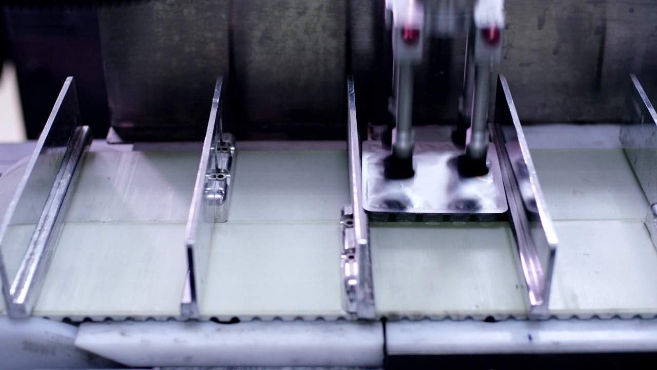 Medical products package on conveyor line at pharmaceutical plant