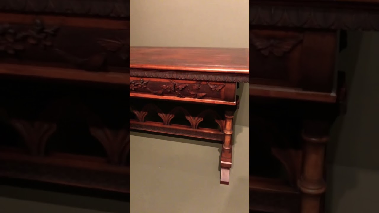 Hand carved butterflies and flowers on the side of a gorgeous library table from 1890 ~