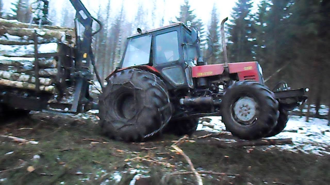 Belarus 1025 forestry tractor with homemade trailer logging in winter forest