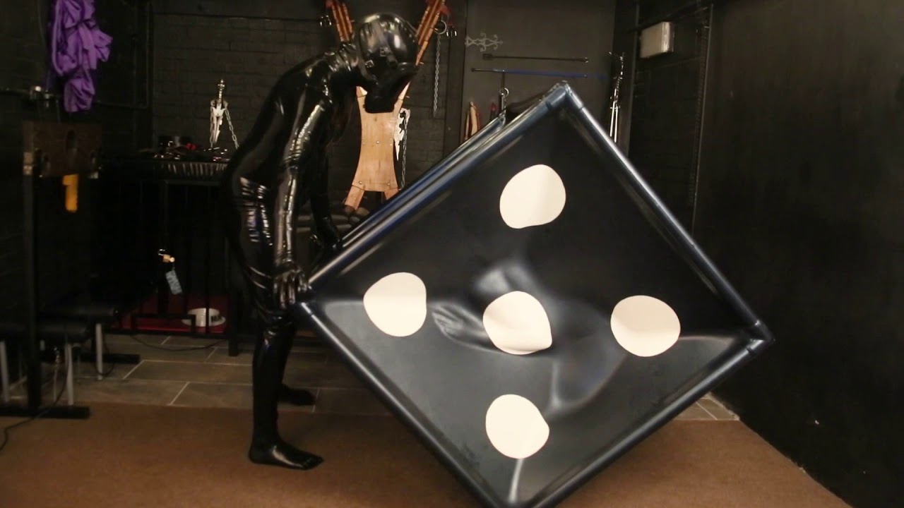 Latex Model has fun in a latex dice