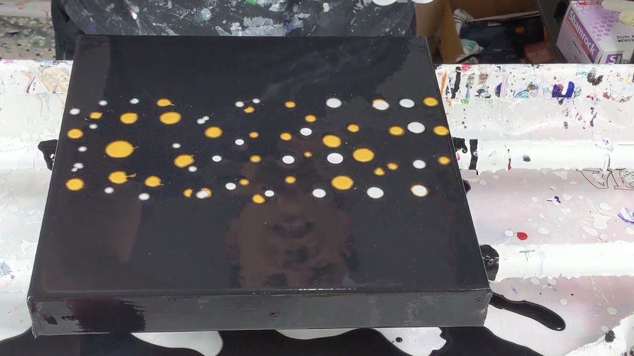 (858) Metallic plastic wrap pour on dark background