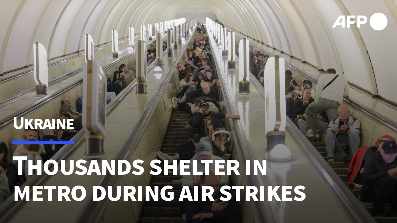 Kyiv residents take shelter inside metro station during massive Russian attack | AFP