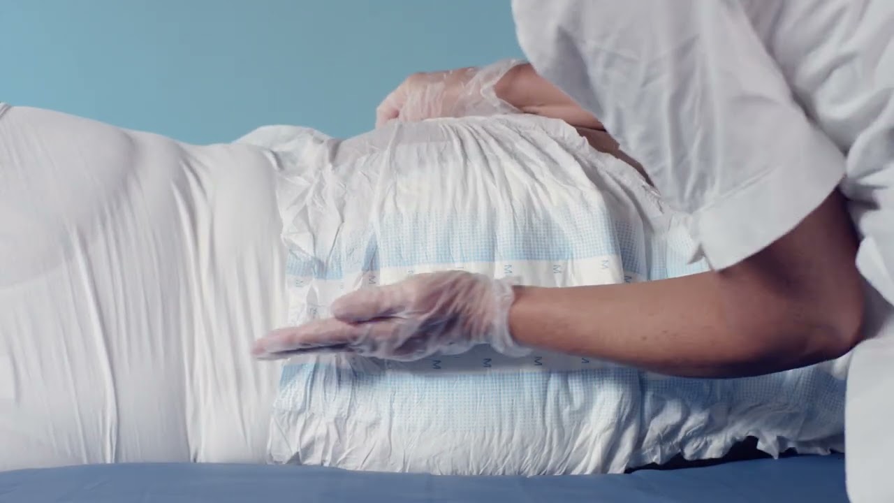Instructions for how to apply TENA Slip Original on a user lying down