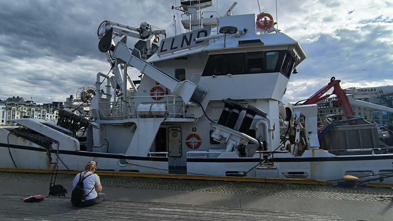 Fishing boats are moored in Ålesund, Norway, for recreation.
