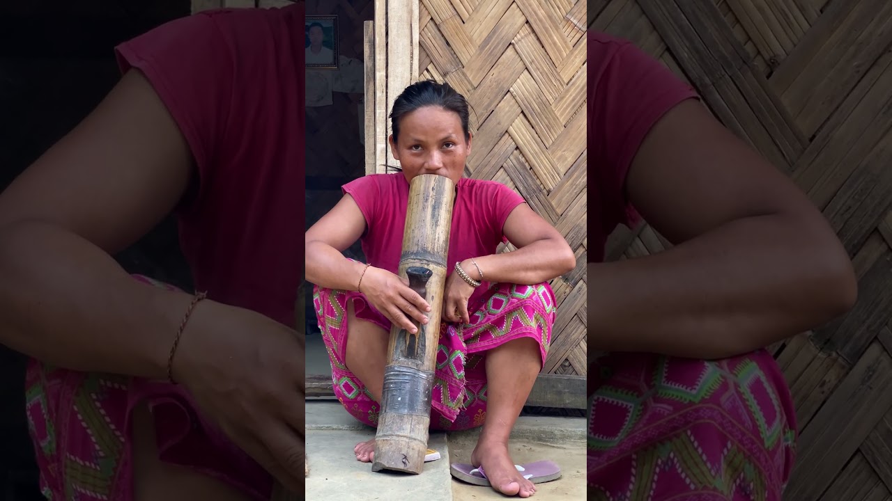 A Woman's Quiet Moment: Smoking a Bamboo Pipe #bangladesh #tribes #smoke