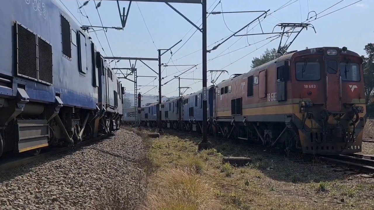 South African Railways,class 18E locomotives crosspiont crew change at Lions River station.