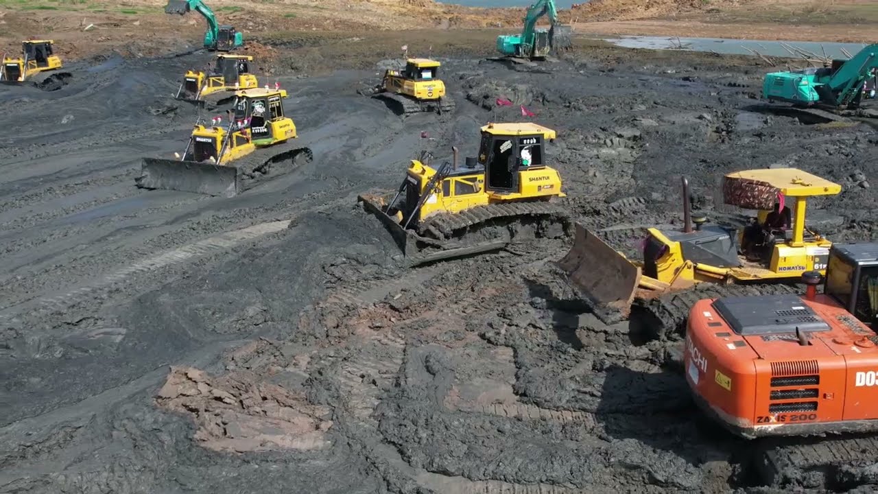 Work ethic stuck in the mud And Bulldozer Pushing Mud Clearing Lake!