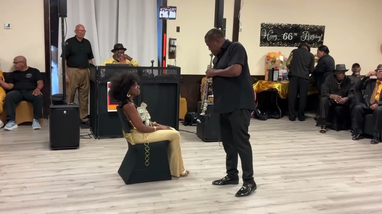 Saxophonist Brian Lenair’s ￼ serenading Karen Collins Reed.  A Birthday present from DJ Blake.