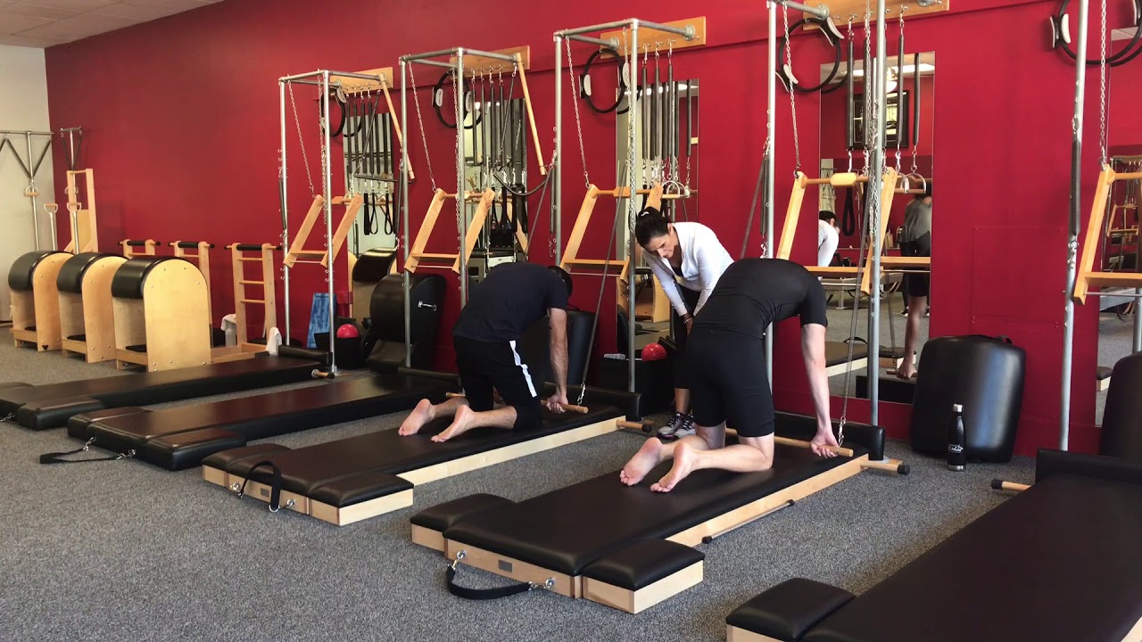 Pilates Tower class variations with the Roll Back Bar