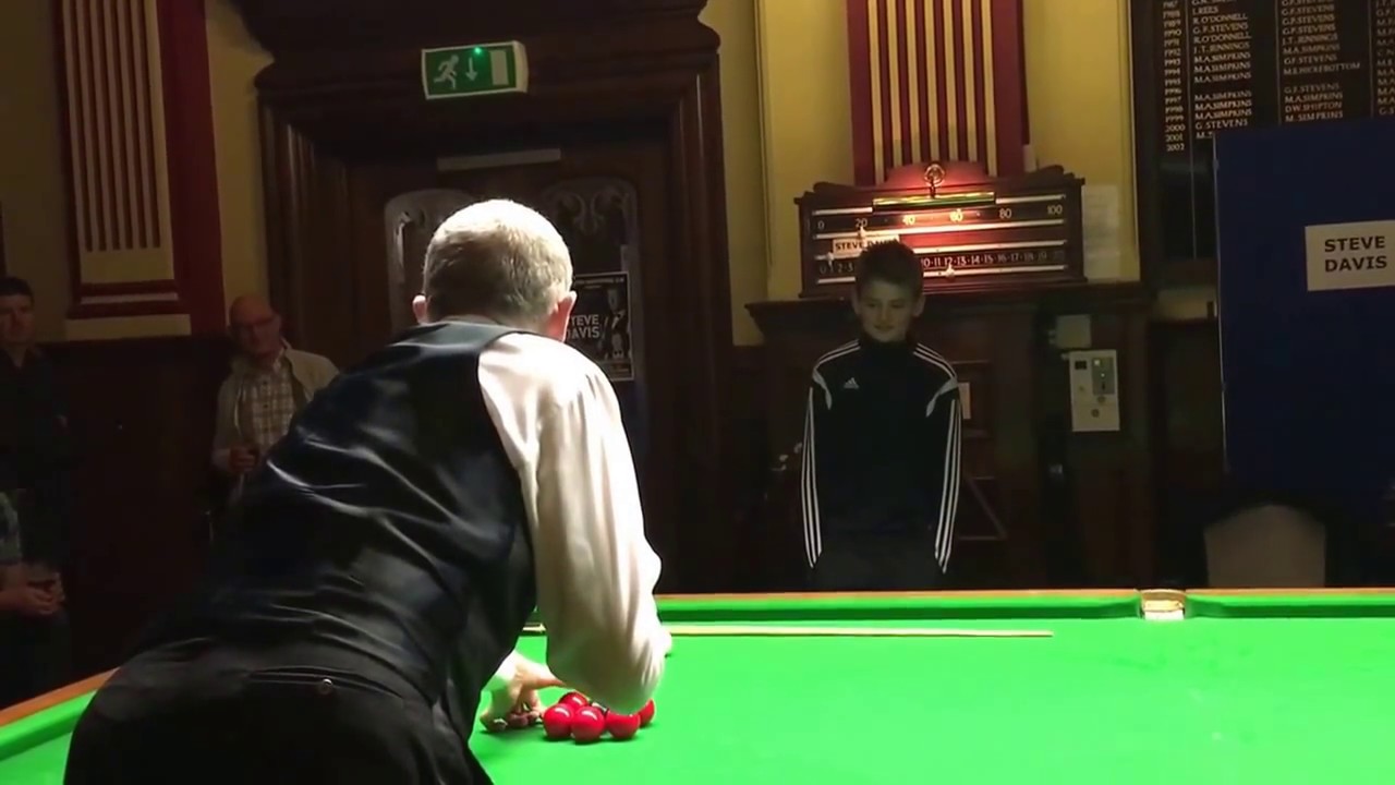Steve Davis doing a couple of trick shots helped out by a young lad Charlie who pots a great black.