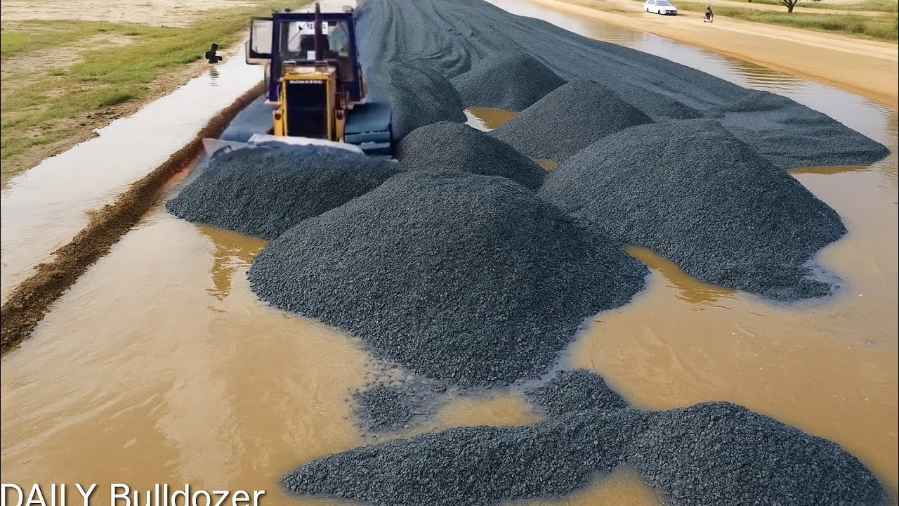Komatsu Bulldozer Pushing Gravel Repairing The High Way Road With 25T Dump Trucks