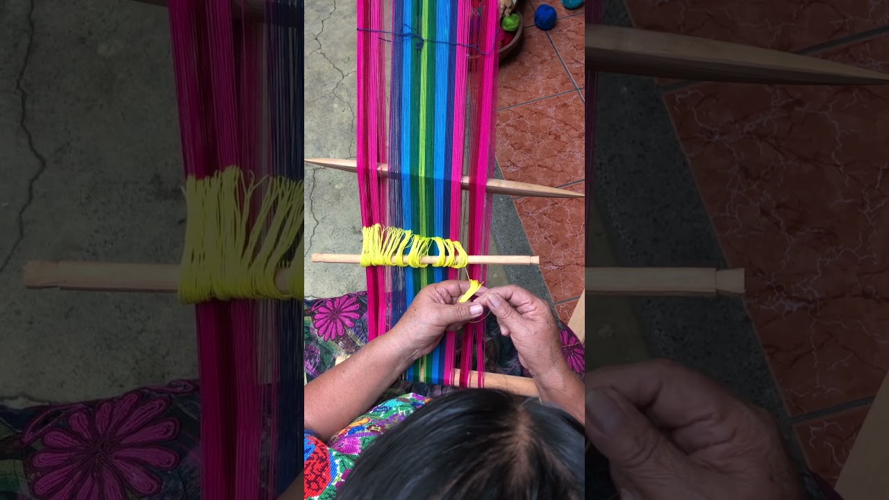 Doña Lidia finishes up the “chocoy” string heddle on a backstrap loom