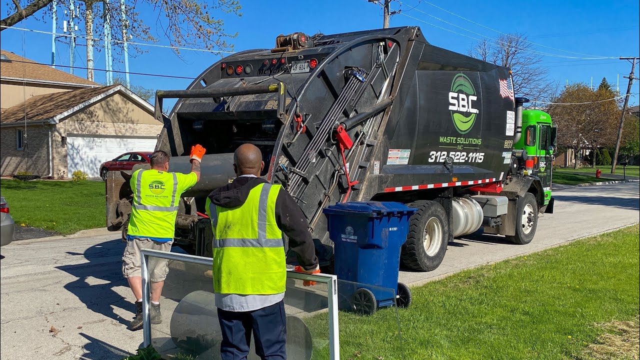 SBC Waste Peterbilt 520 McNeilus Rear Loader Garbage Truck Packing Bulk at the Spring Cleanup