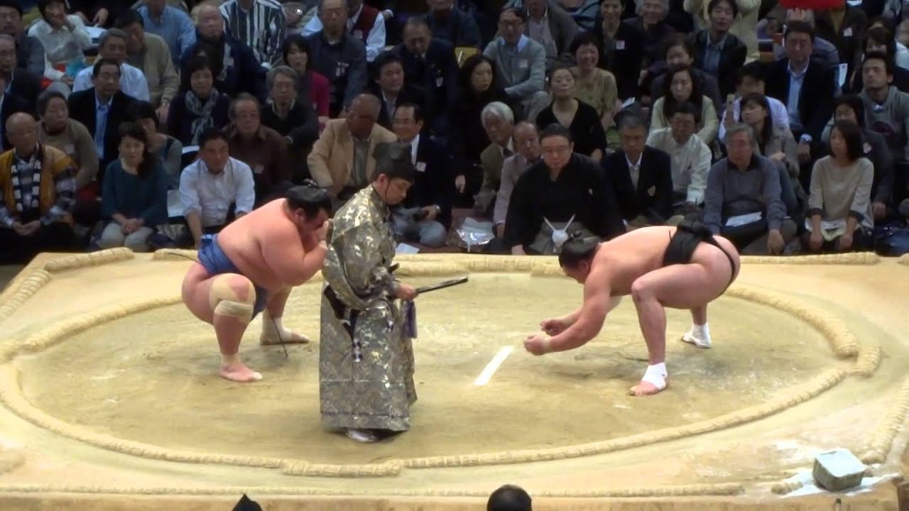 Sumo Wrestler Throws Opponent Out of Ring