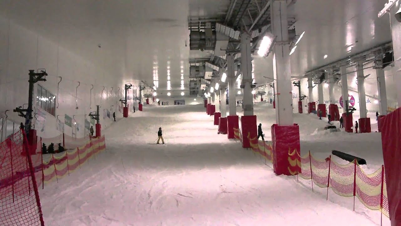 skier does imposible jump at indoor ski slope