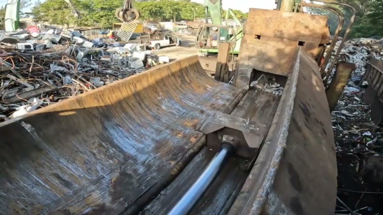 perfect cuts with heavy machinery in a scrapyard