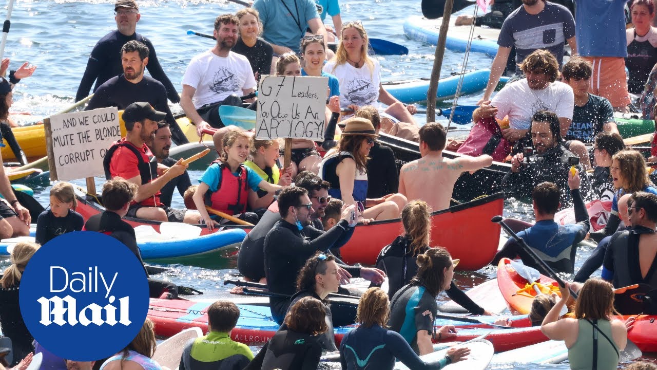 More than 1,000 of surfers stage paddle-out protest at G7 Summit
