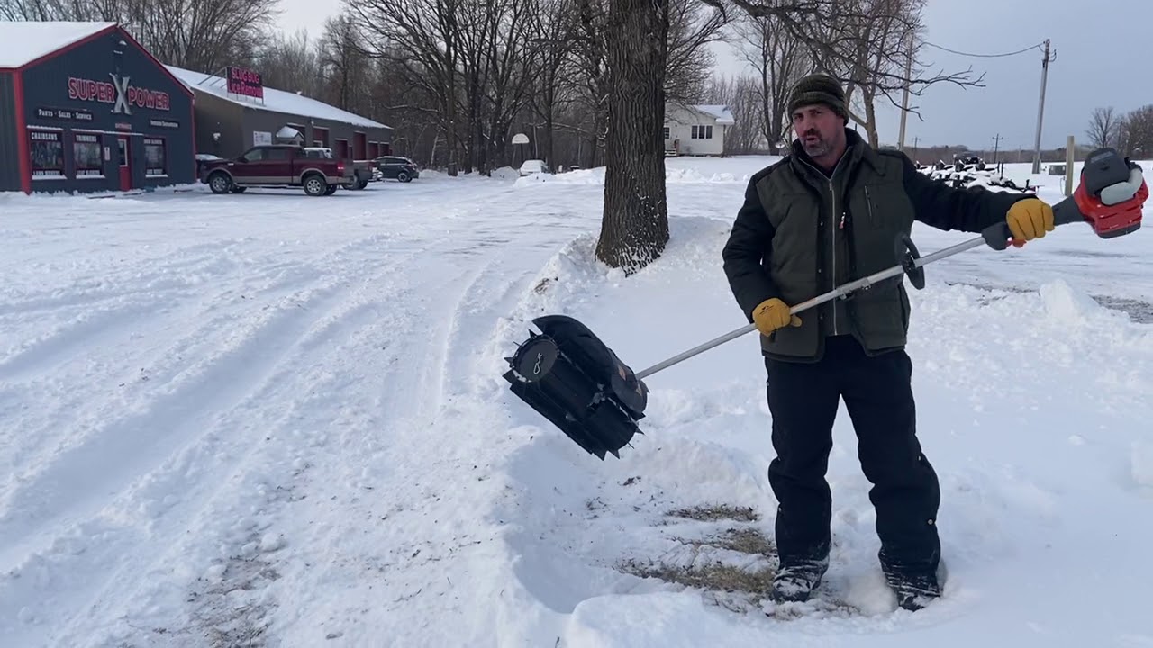 Husqvarna Power Sweeper moving snow at Super X Power in Milaca MN