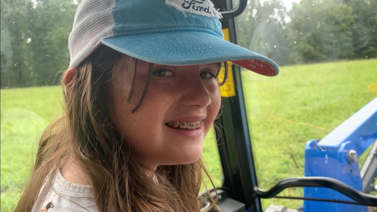 Daddy-Daighter in the New Holland Workmaster 75 feeding horses