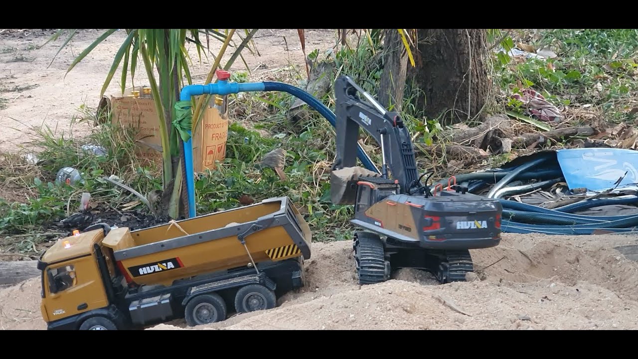 Miniature Construction Site: RC Excavator and Dump Truck at Work