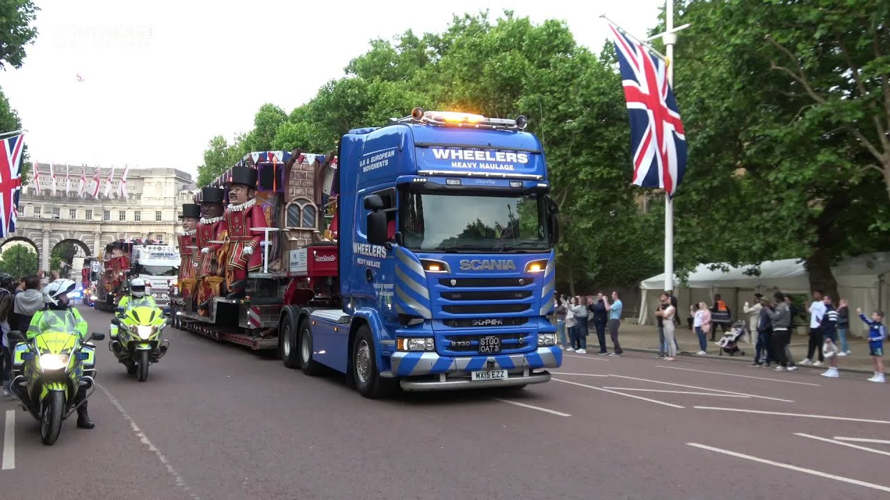 Convoy of trucks carry 100ft long carnival cart down The Mall ahead of the Platinum Jubilee Pageant